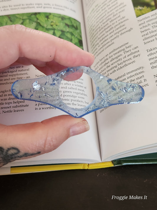 Thumb grip book page holder